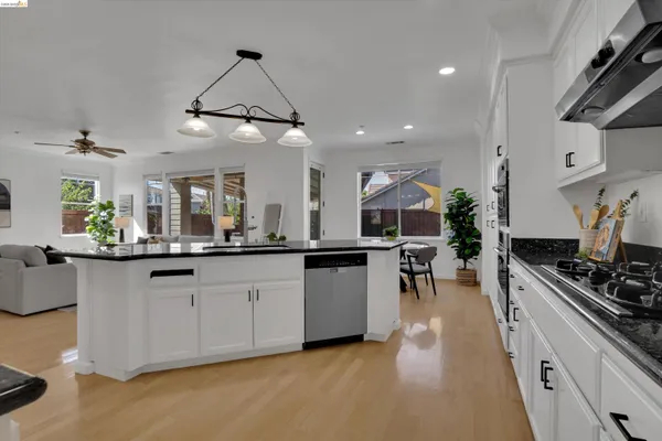 a kitchen with lots of counter top space and wooden floor
