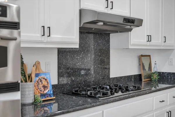 a kitchen with a stove and cabinets