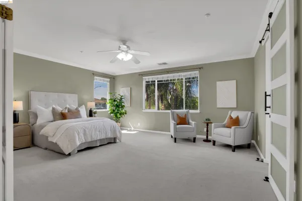 a spacious bedroom with a bed and a couch