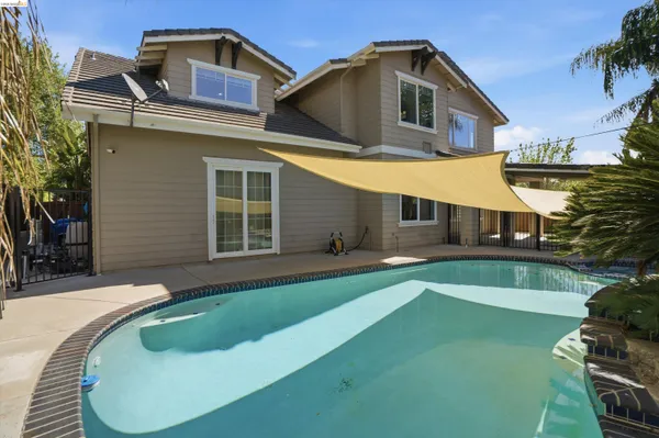 a view of a swimming pool with a yard