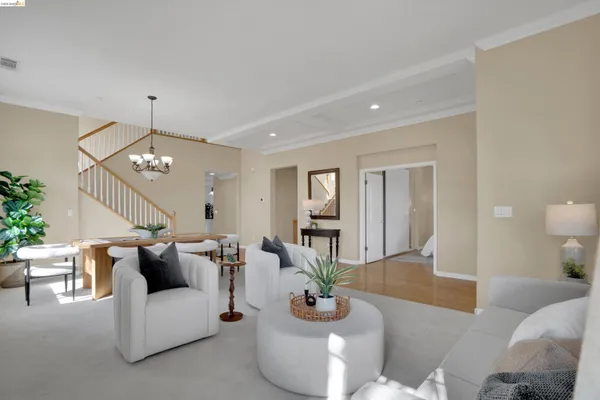 a living room with furniture and a chandelier