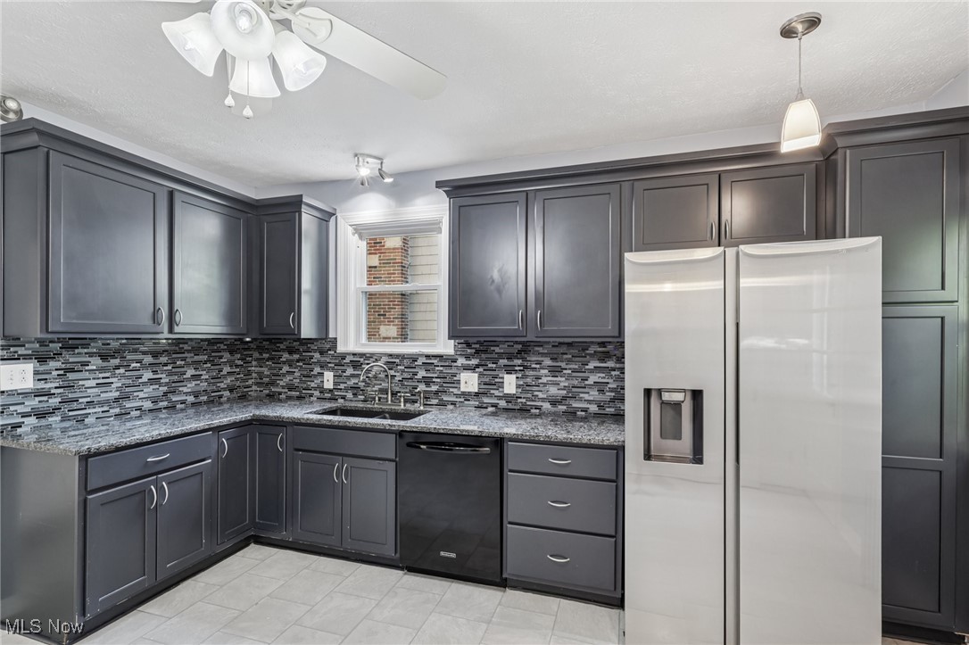 3621 Cedarbrook Road Cleveland, OH 44118 - Photo 4 of 40 Kitchen featuring stainless steel fridge, dark stone countertops, dishwasher, and tasteful backsplash