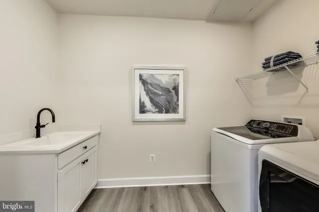 a utility room with sink dryer and washer