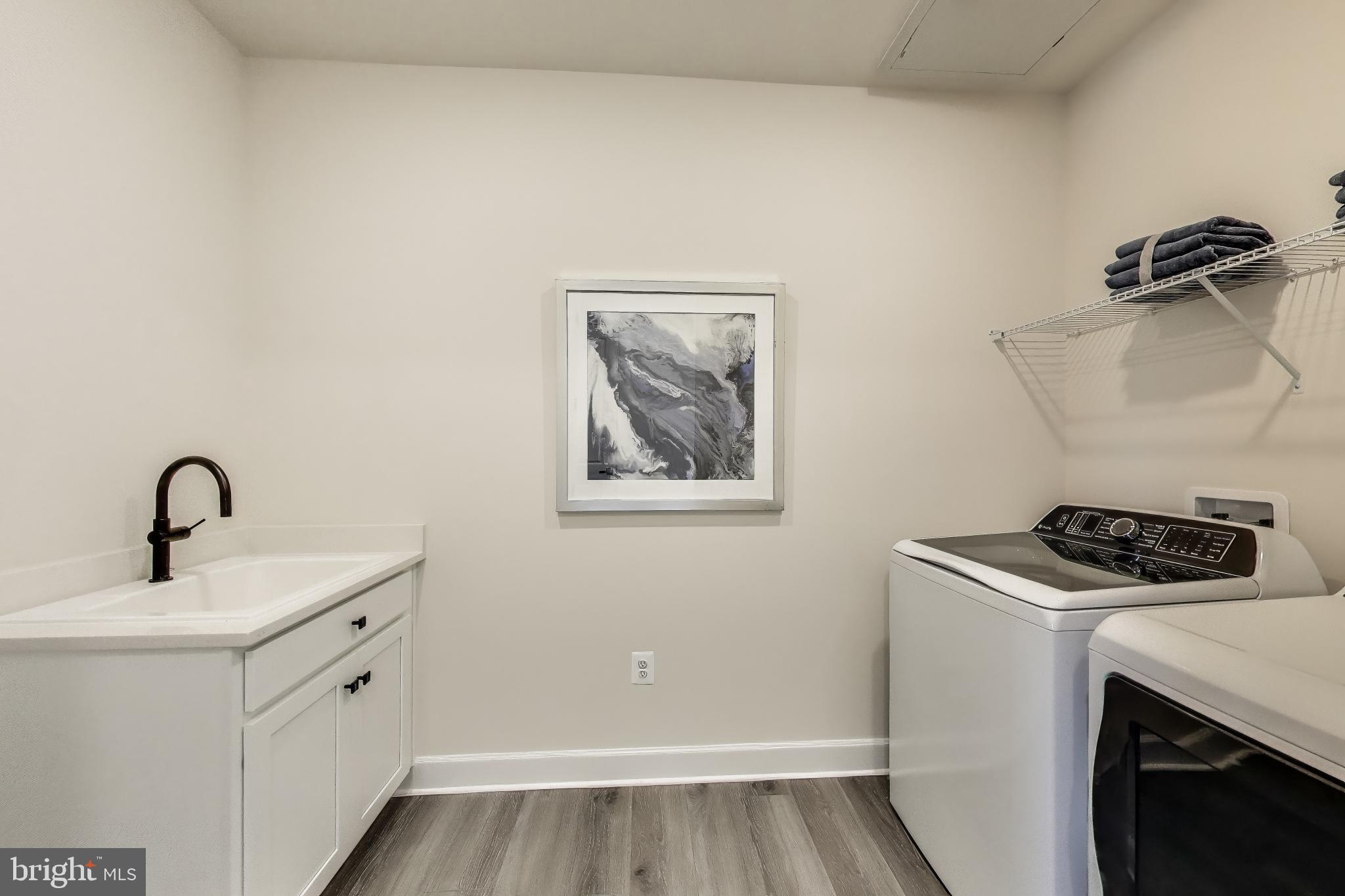 141 Collington Place Laurel, MD 20708 - Photo 11 of 15 a utility room with sink dryer and washer