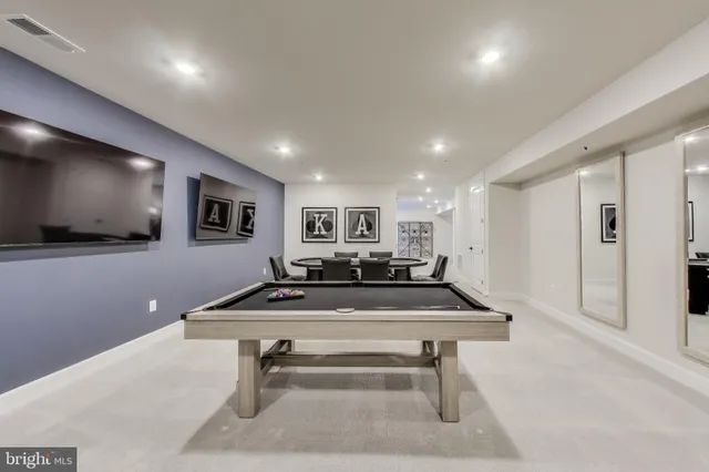 a room with furniture pool table and flat screen tv