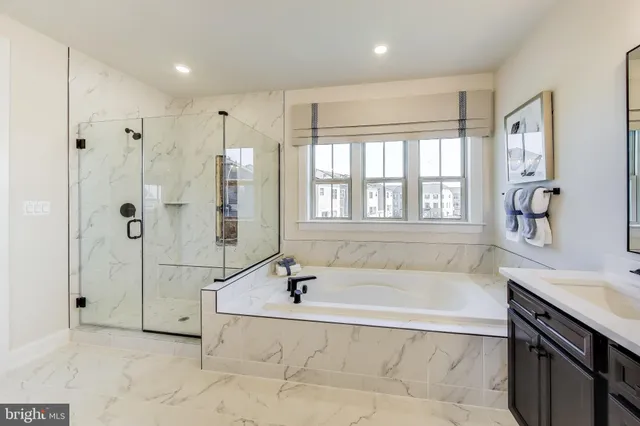 a spacious bathroom with a tub shower and sink