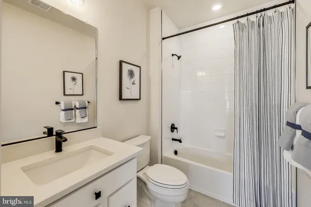 a bathroom with a sink toilet a mirror and shower