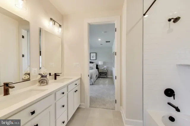 a bathroom with double sink and a mirror