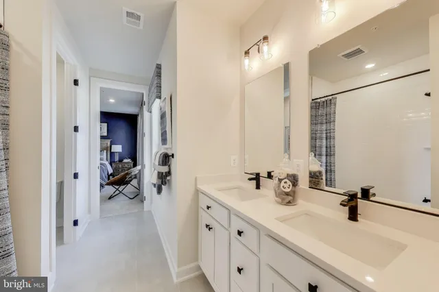 a bathroom with a double vanity sink and mirror