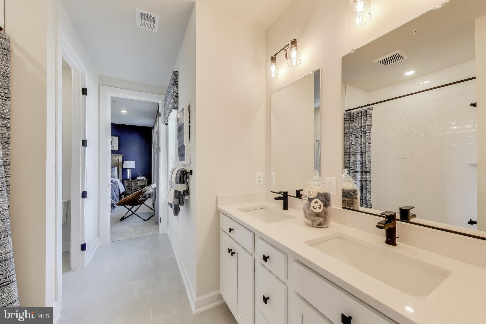 141 Collington Place Laurel, MD 20708 - Photo 8 of 15 a bathroom with a double vanity sink and mirror