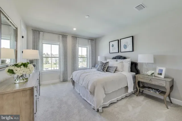 a spacious bedroom with a bed and a window