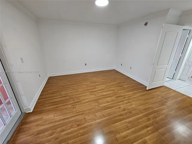 a view of a room with wooden floor