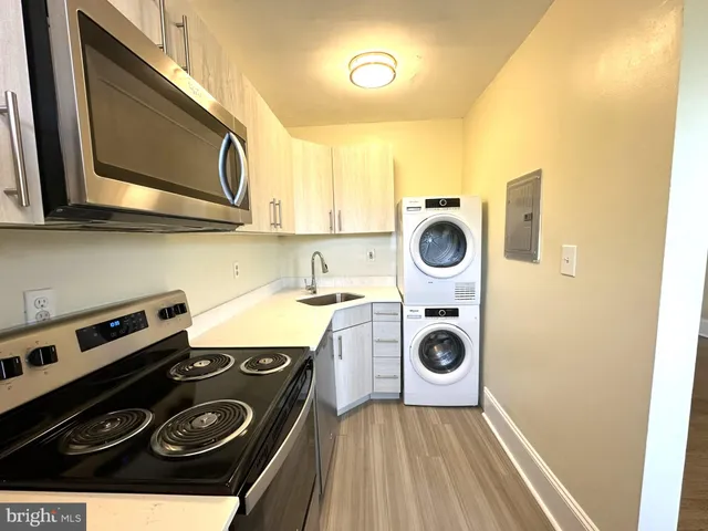 a view of a kitchen with a stove top oven