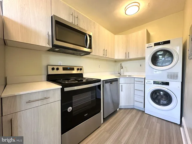 a kitchen with a stove top oven sink and cabinets