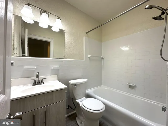 a bathroom with a sink a toilet and a bathtub