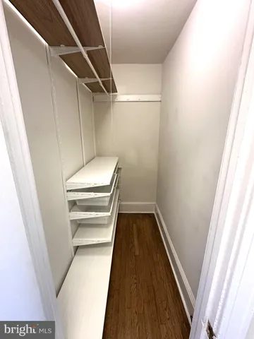 a view of walk in closet with empty racks