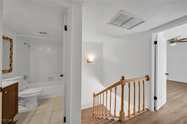 a bathroom with a toilet sink and shower