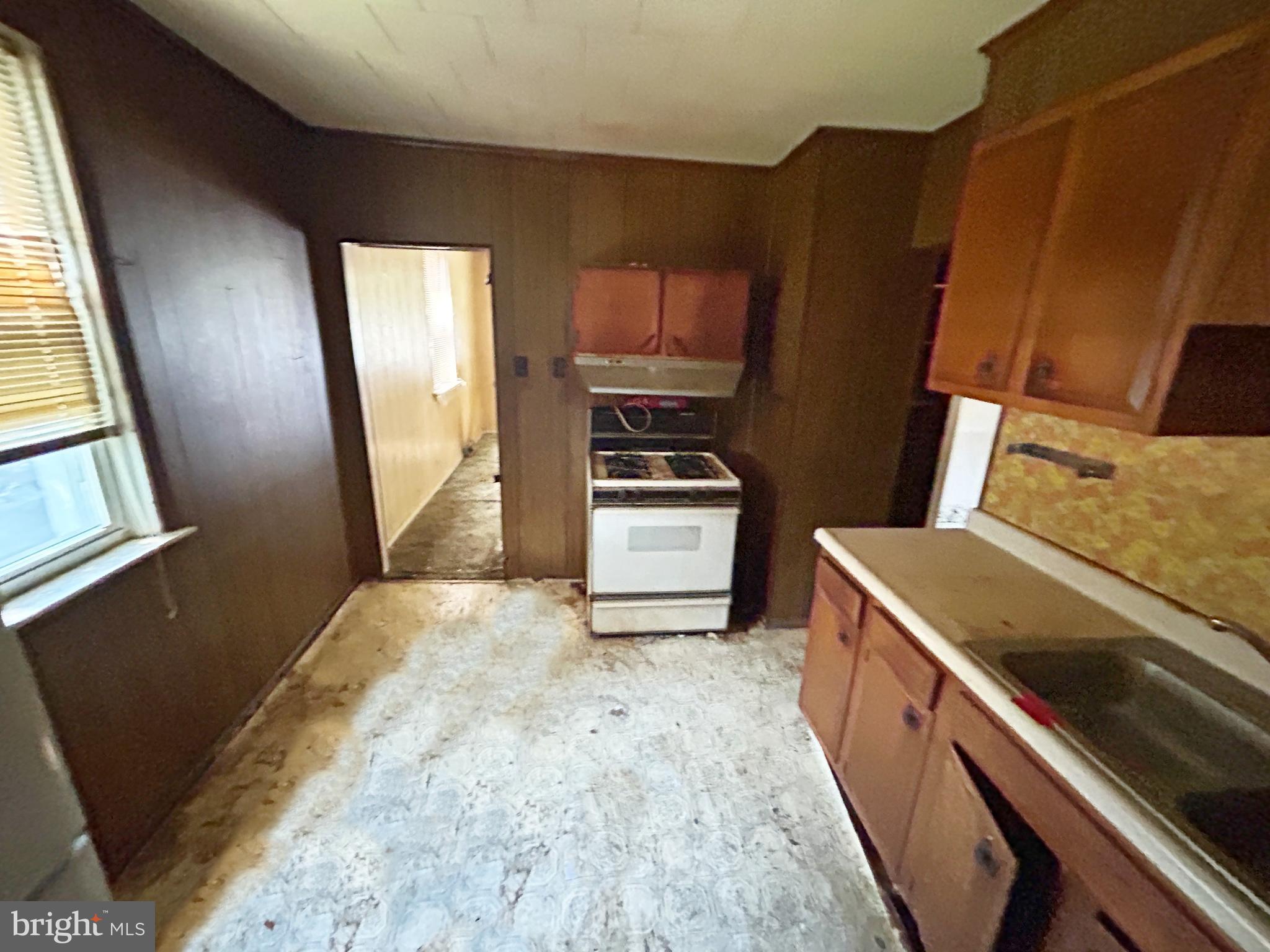 200 Pinewood Road Dundalk, MD 21222 - Photo 8 of 14 a kitchen with wooden cabinets and a stove top oven