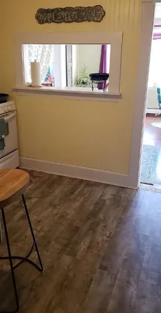 a view of a room with rack on the wall and a window