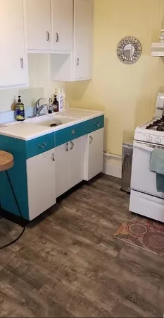 a kitchen with a cabinets and white appliances