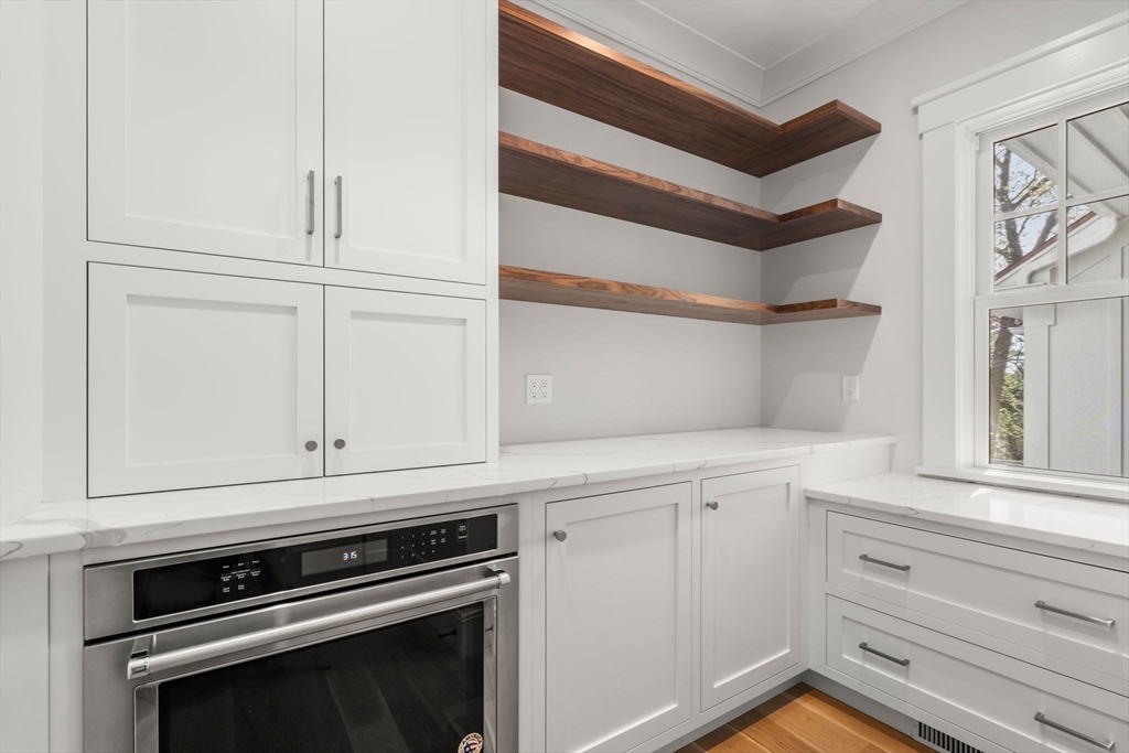 22 Temple Road Wellesley, MA 02482 - Photo 16 of 41 a kitchen with white cabinets and appliances