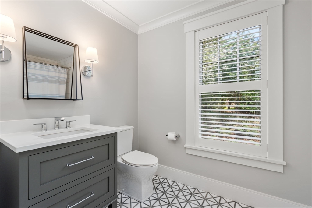 22 Temple Road Wellesley, MA 02482 - Photo 27 of 41 a bathroom with a toilet a sink and a window