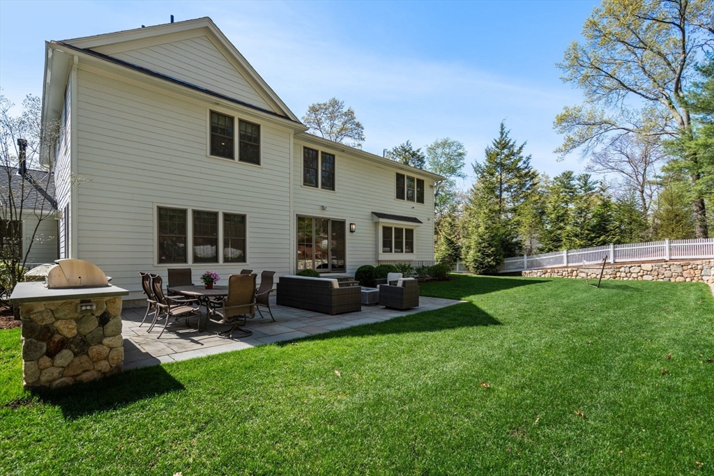 22 Temple Road Wellesley, MA 02482 - Photo 38 of 41 a backyard of a house with table and chairs