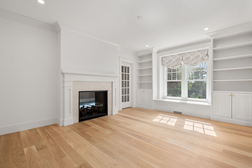 22 Temple Road Wellesley, MA 02482 - Photo 4 of 41 a view of an empty room with a window and a fireplace