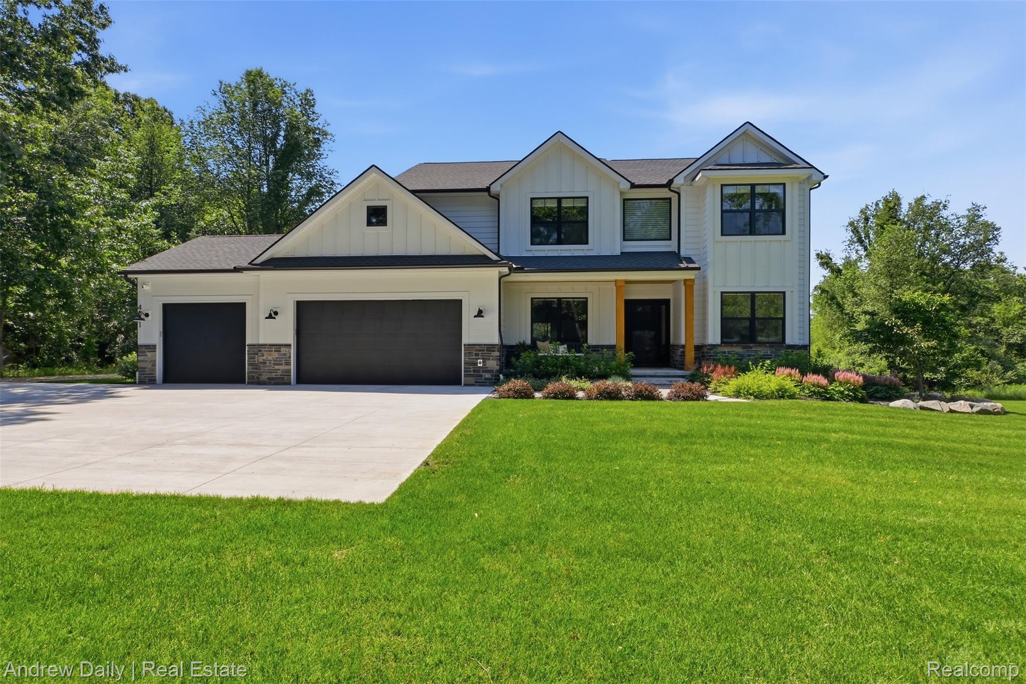 4661 Spears Road Pinckney, MI 48169 - Photo 2 of 56 Modern farmhouse exterior featuring board and batten siding and stone accents
