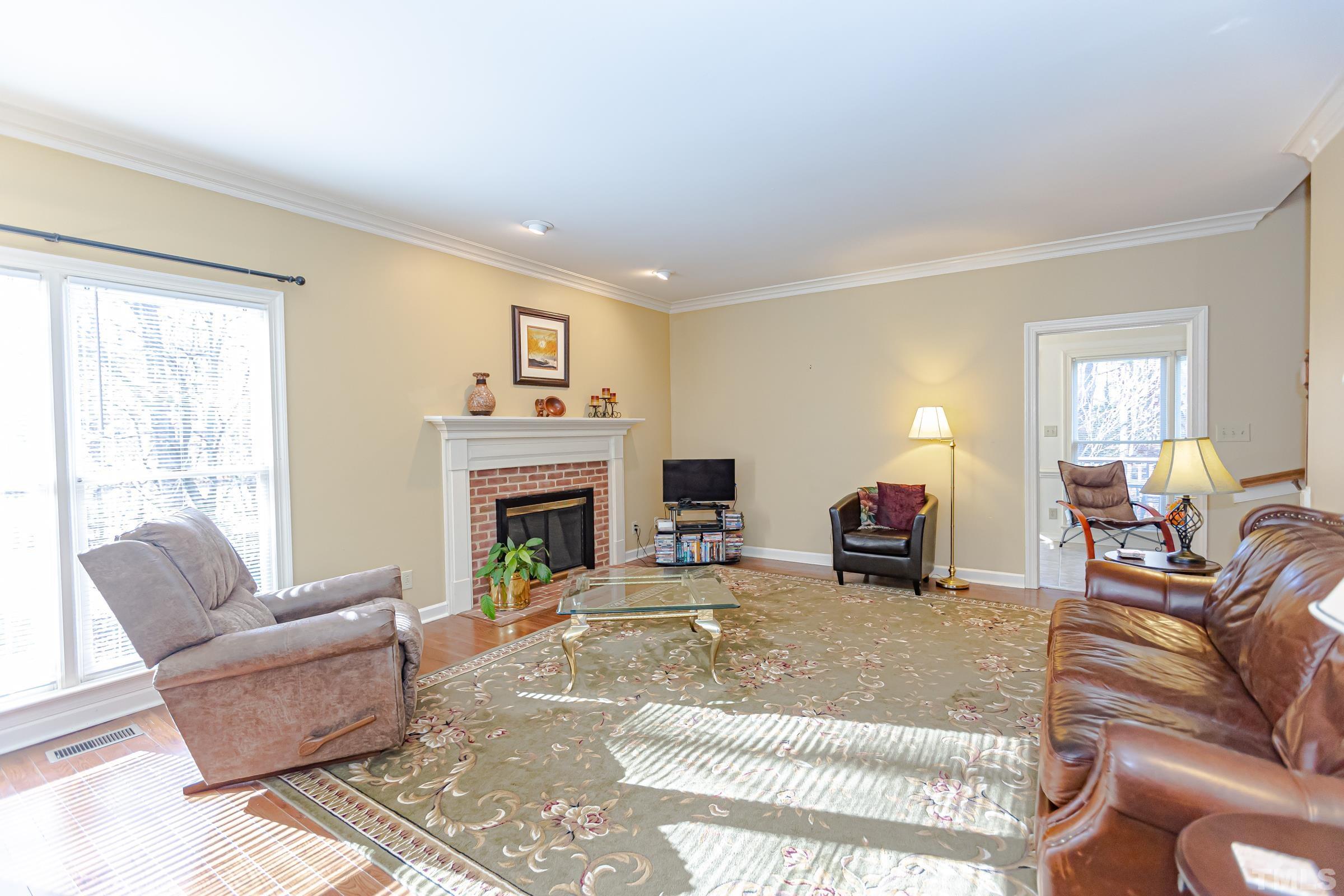 410 Weathergreen Drive Raleigh, NC 27615 - Photo 14 of 44 a living room with furniture and a fireplace
