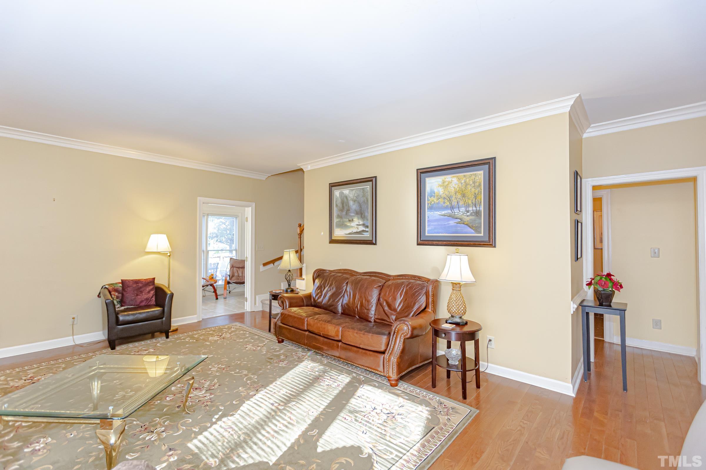 410 Weathergreen Drive Raleigh, NC 27615 - Photo 15 of 44 a living room with furniture and wooden floor