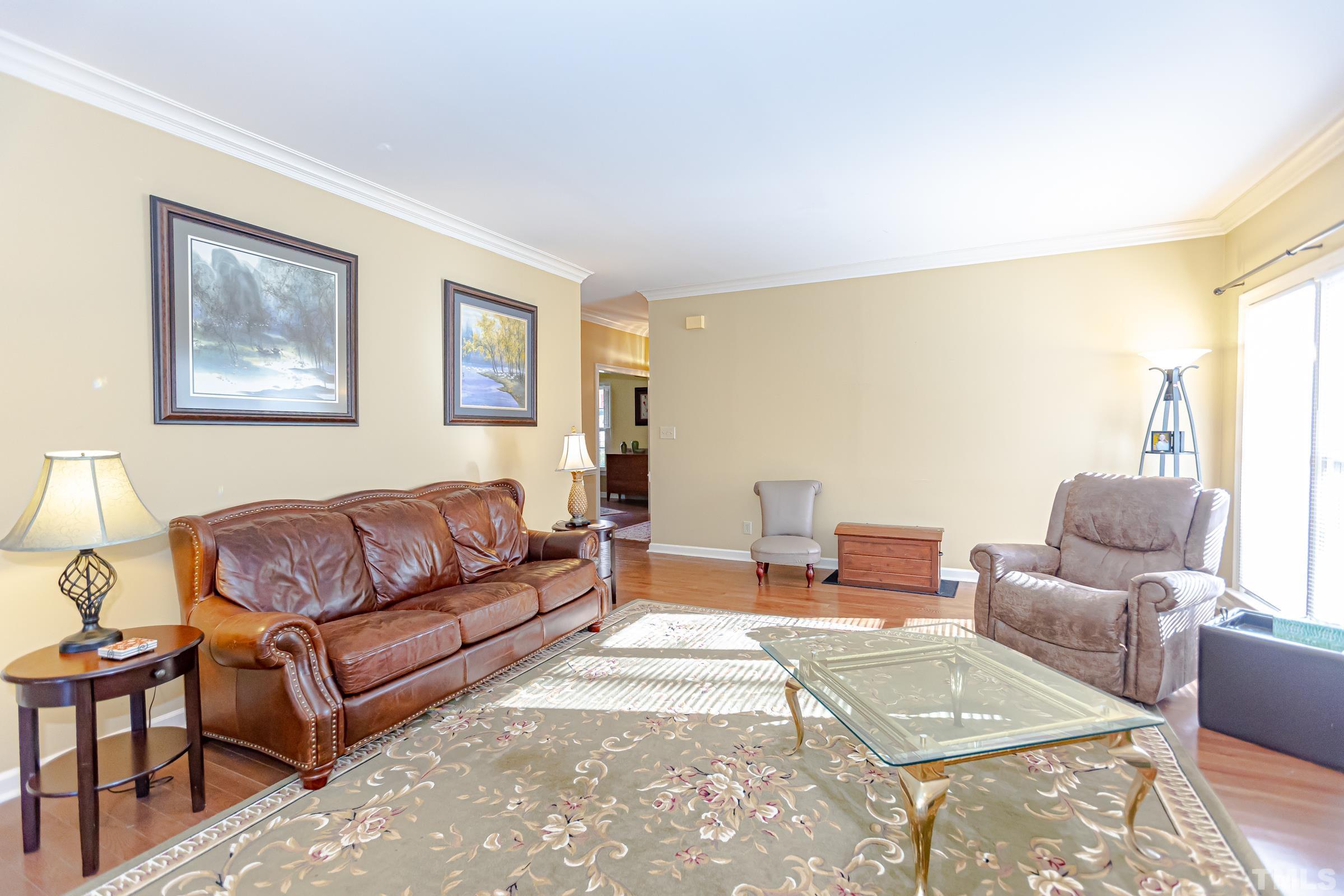 410 Weathergreen Drive Raleigh, NC 27615 - Photo 16 of 44 a living room with furniture or couch and a wooden floor