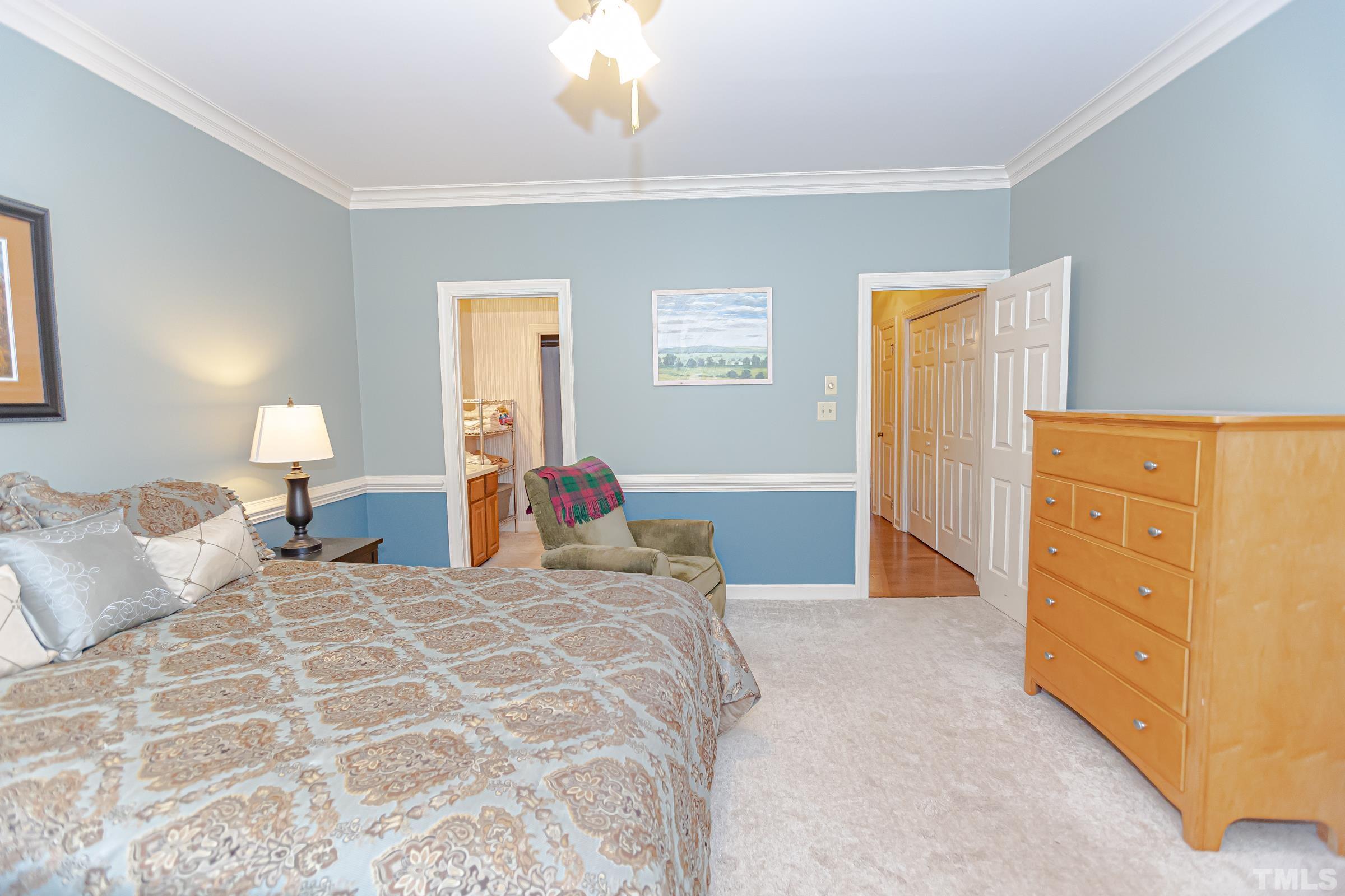 410 Weathergreen Drive Raleigh, NC 27615 - Photo 21 of 44 a bedroom with a bed and a dresser
