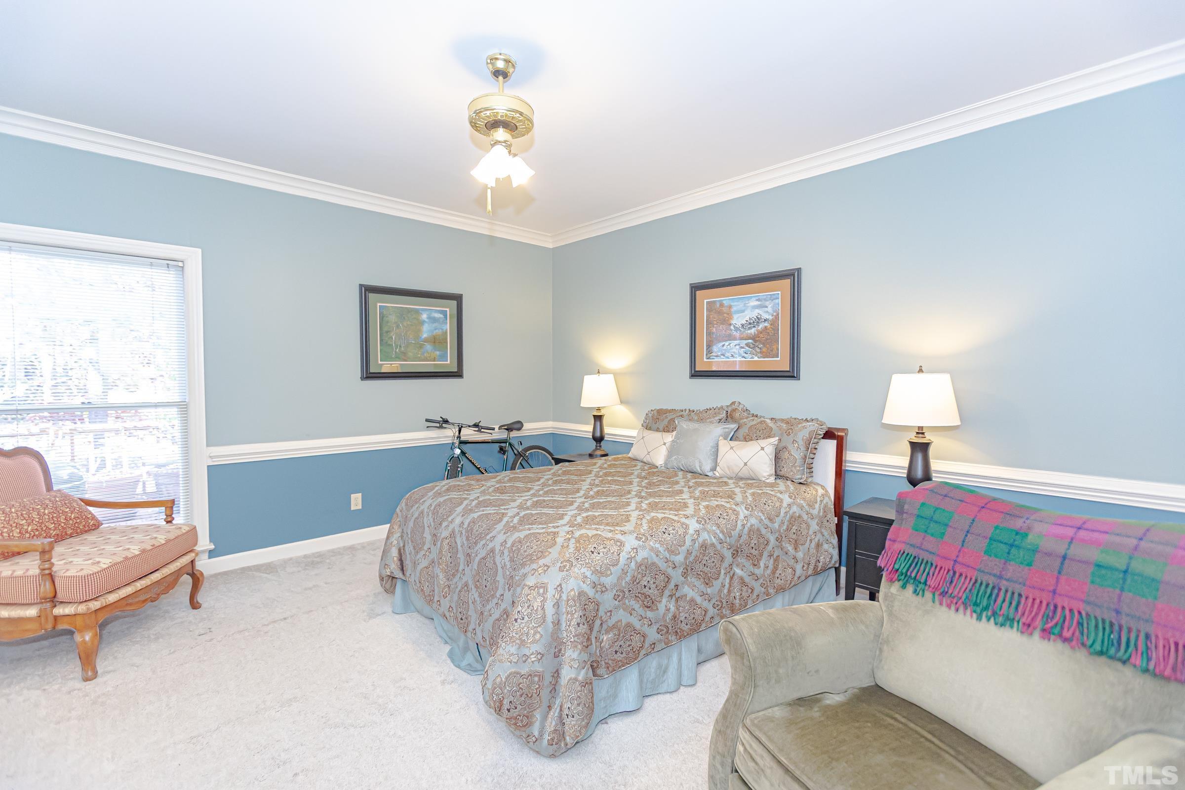 410 Weathergreen Drive Raleigh, NC 27615 - Photo 22 of 44 a bed room with a bed and a chair