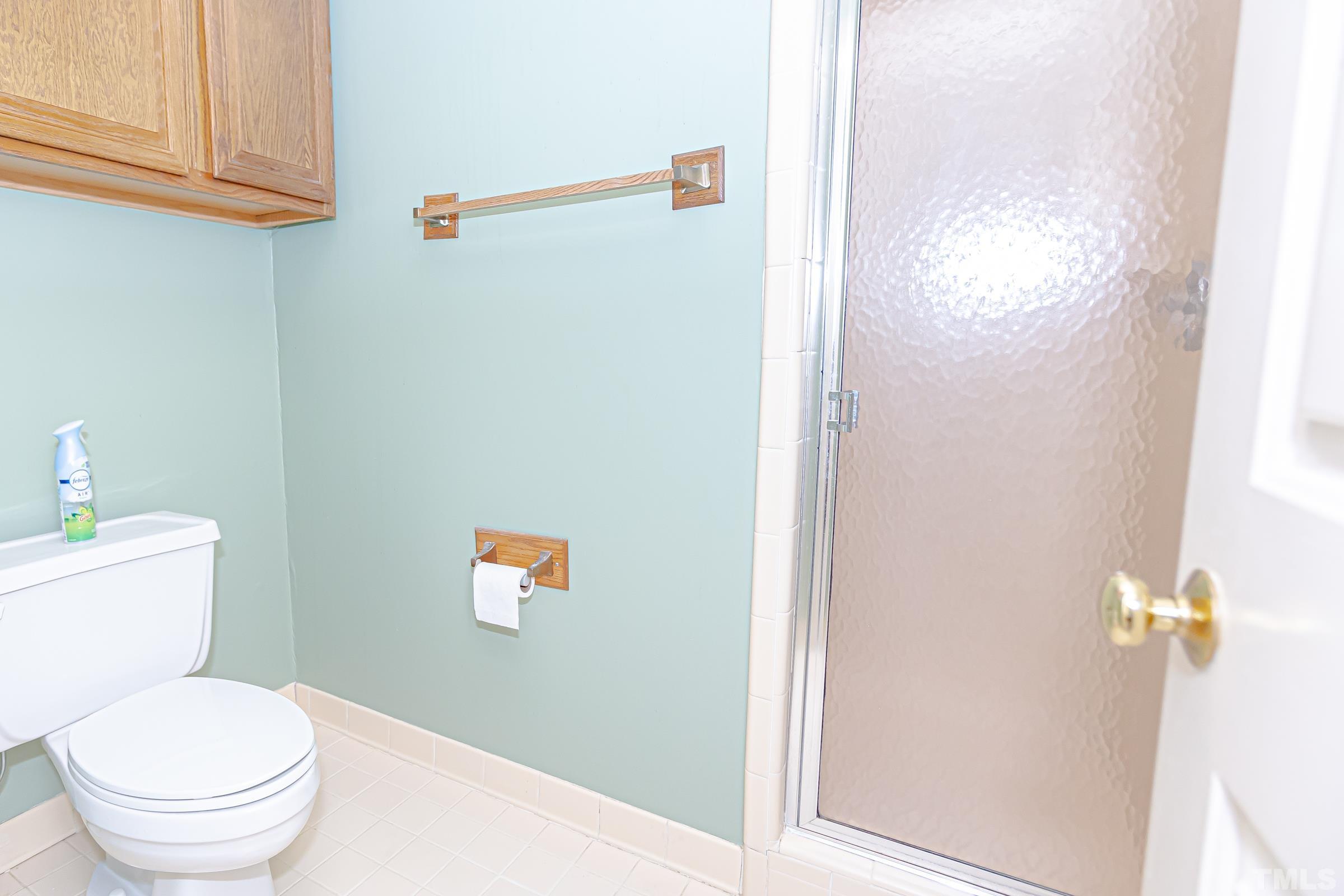 410 Weathergreen Drive Raleigh, NC 27615 - Photo 28 of 44 a white toilet sitting next to a bathroom sink