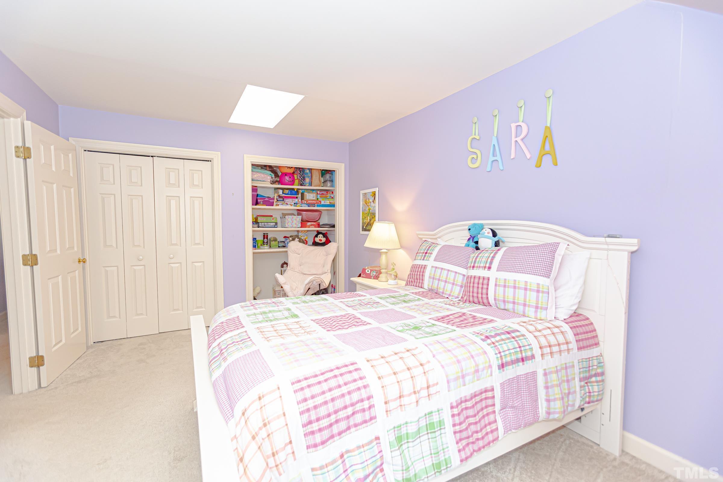 410 Weathergreen Drive Raleigh, NC 27615 - Photo 30 of 44 a bedroom with a bed and a book shelf