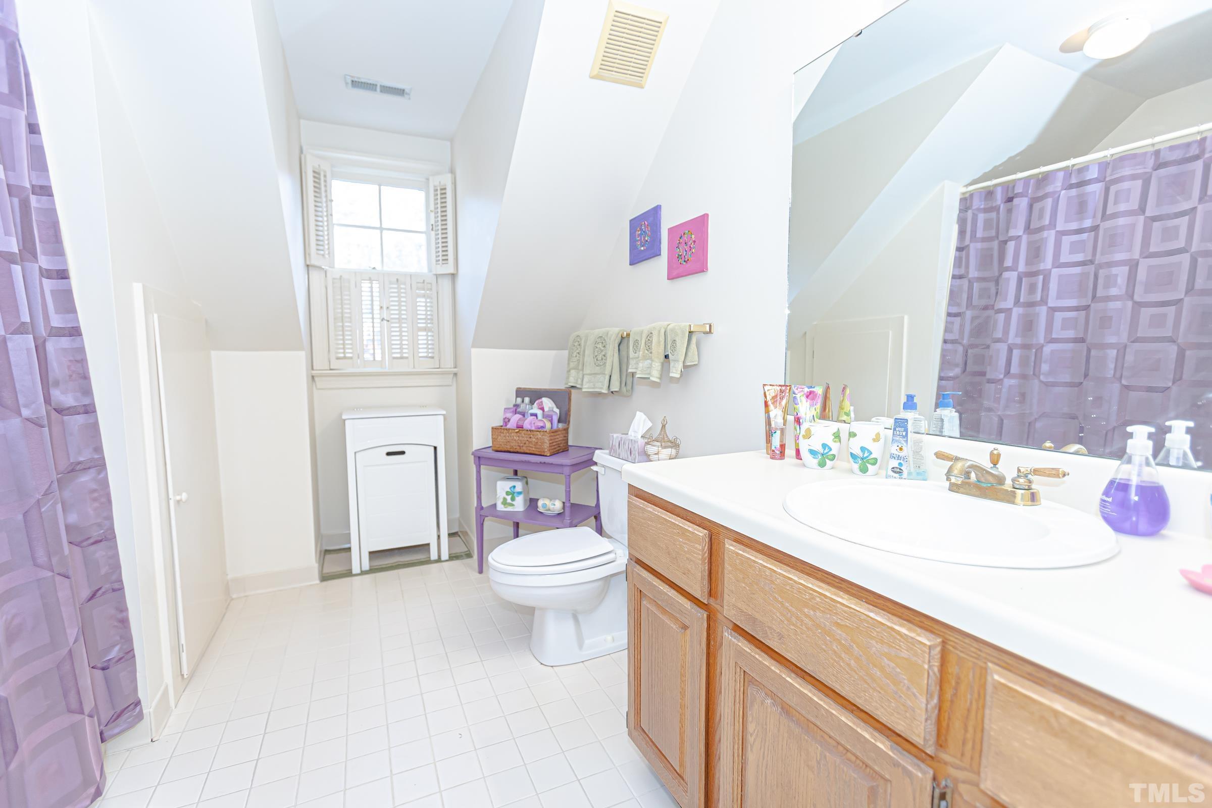 410 Weathergreen Drive Raleigh, NC 27615 - Photo 32 of 44 a bathroom with a sink toilet vanity and window