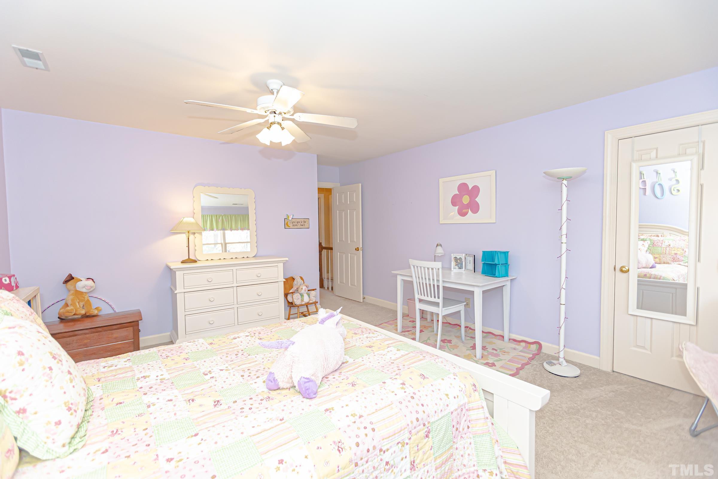 410 Weathergreen Drive Raleigh, NC 27615 - Photo 35 of 44 a bedroom with a bed and a chandelier