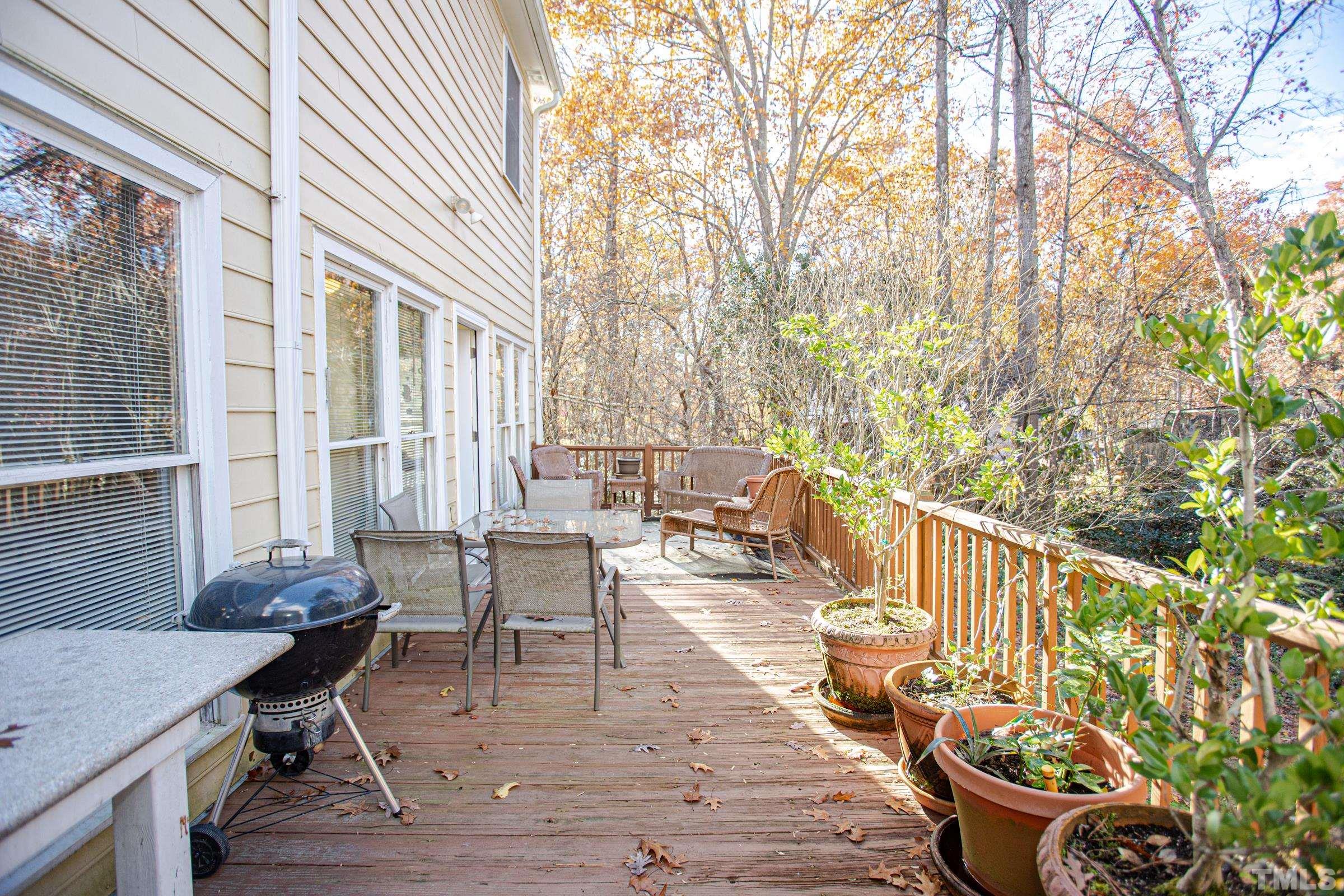 410 Weathergreen Drive Raleigh, NC 27615 - Photo 38 of 44 a view of a patio with couches table and chairs and potted plants