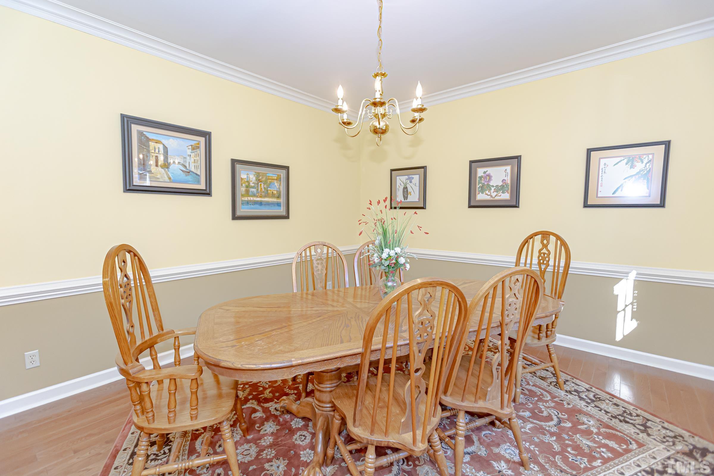 410 Weathergreen Drive Raleigh, NC 27615 - Photo 5 of 44 a view of a dining room with furniture and chandelier