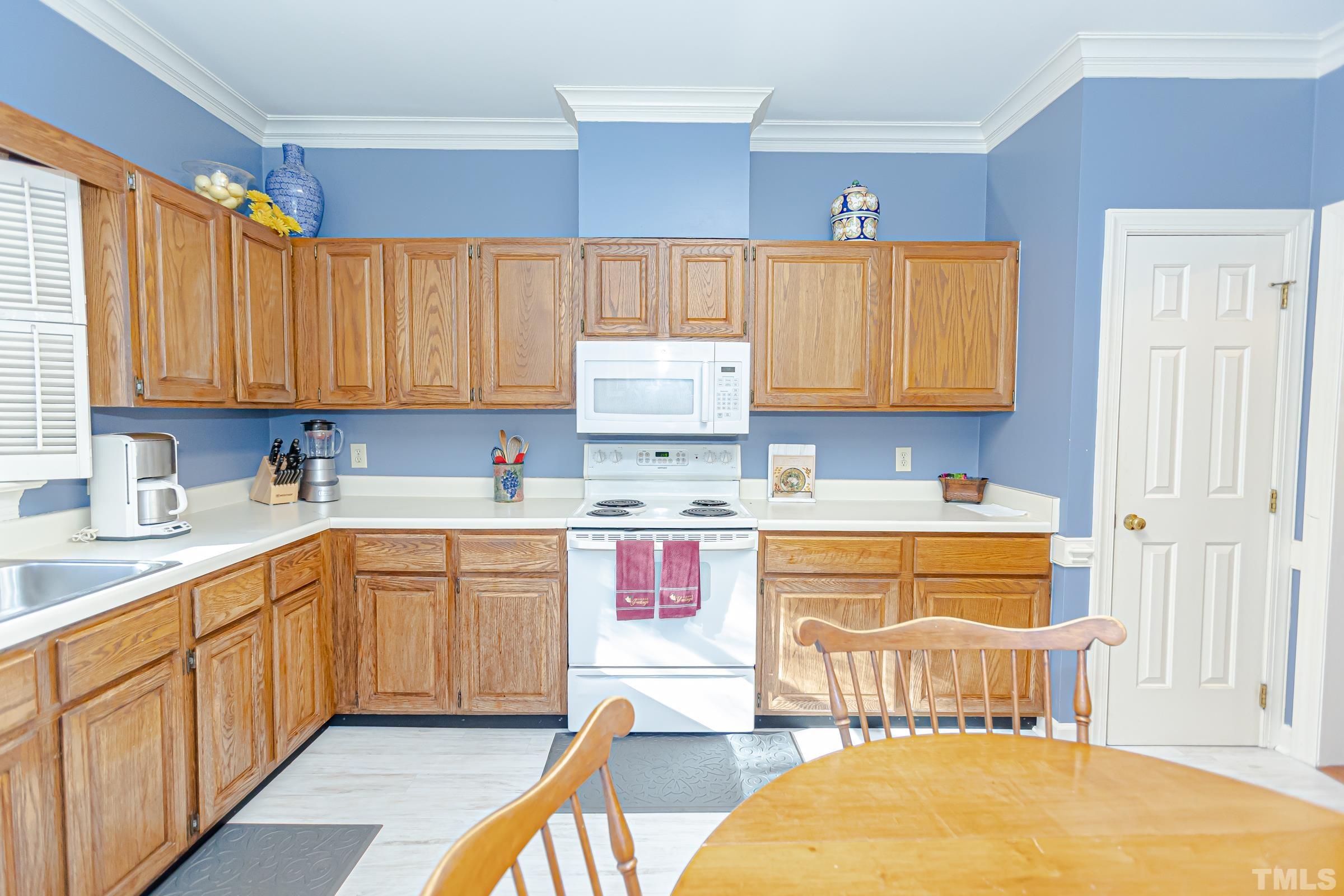 410 Weathergreen Drive Raleigh, NC 27615 - Photo 10 of 44 a kitchen with stainless steel appliances granite countertop a stove a sink and a microwave