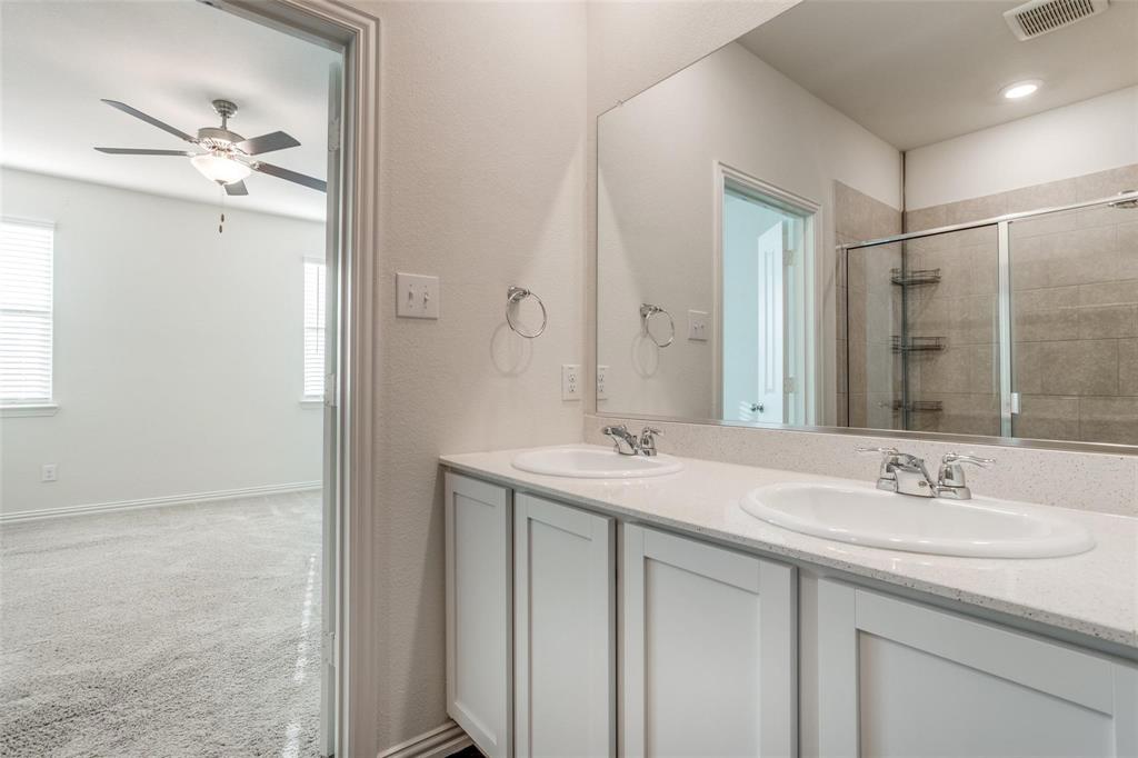 309 Hackberry Street Princeton, TX 75407 - Photo 15 of 28 a bathroom with a sink double vanity and a mirror