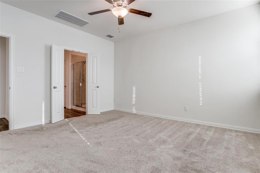 309 Hackberry Street Princeton, TX 75407 - Photo 20 of 28 an empty room with a ceiling fan and a window