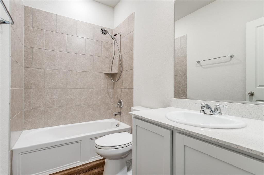 309 Hackberry Street Princeton, TX 75407 - Photo 21 of 28 a bathroom with a sink a toilet and shower