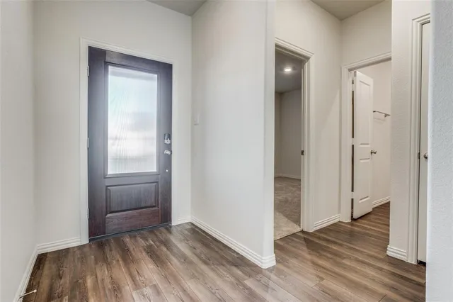 a view of a hallway with wooden floor