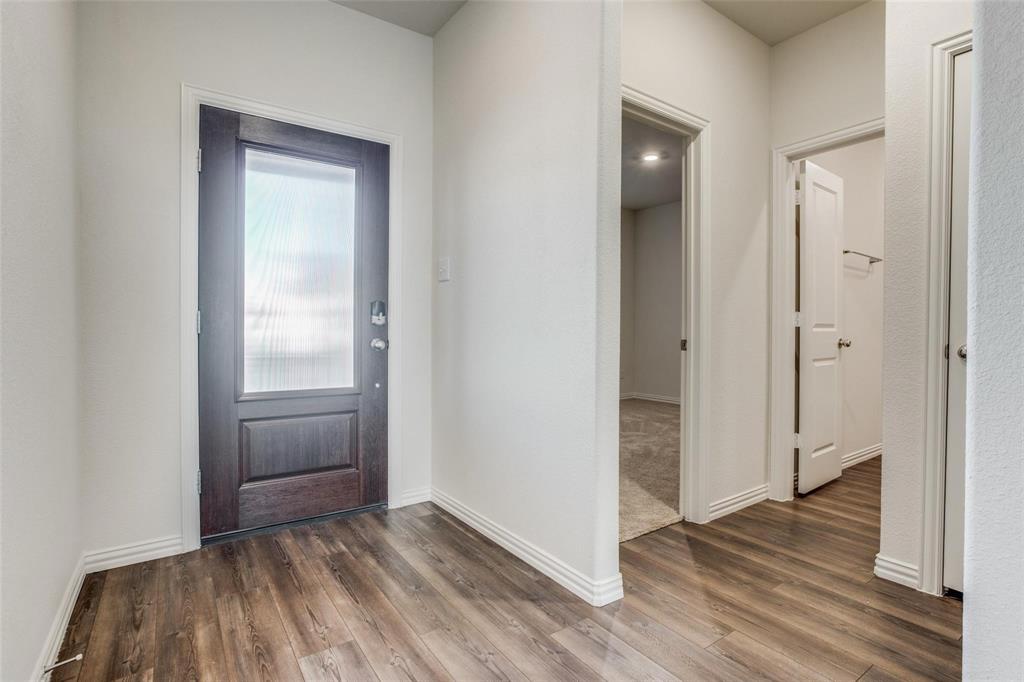 309 Hackberry Street Princeton, TX 75407 - Photo 9 of 28 an empty room with closet and wooden floor