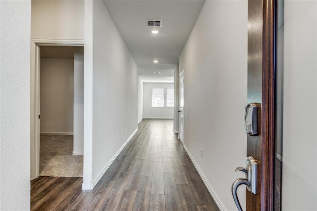 309 Hackberry Street Princeton, TX 75407 - Photo 10 of 28 a view of a hallway with wooden floor