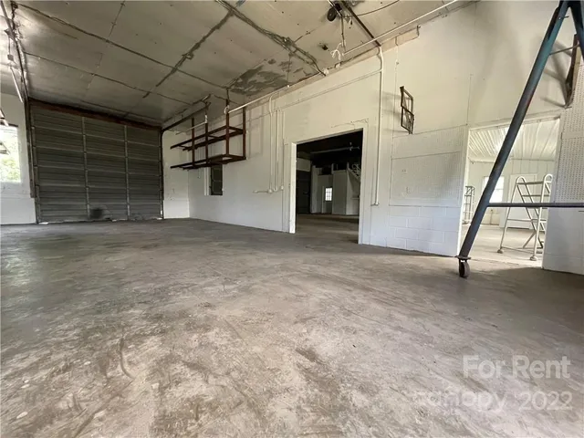 a view of empty room with white walls