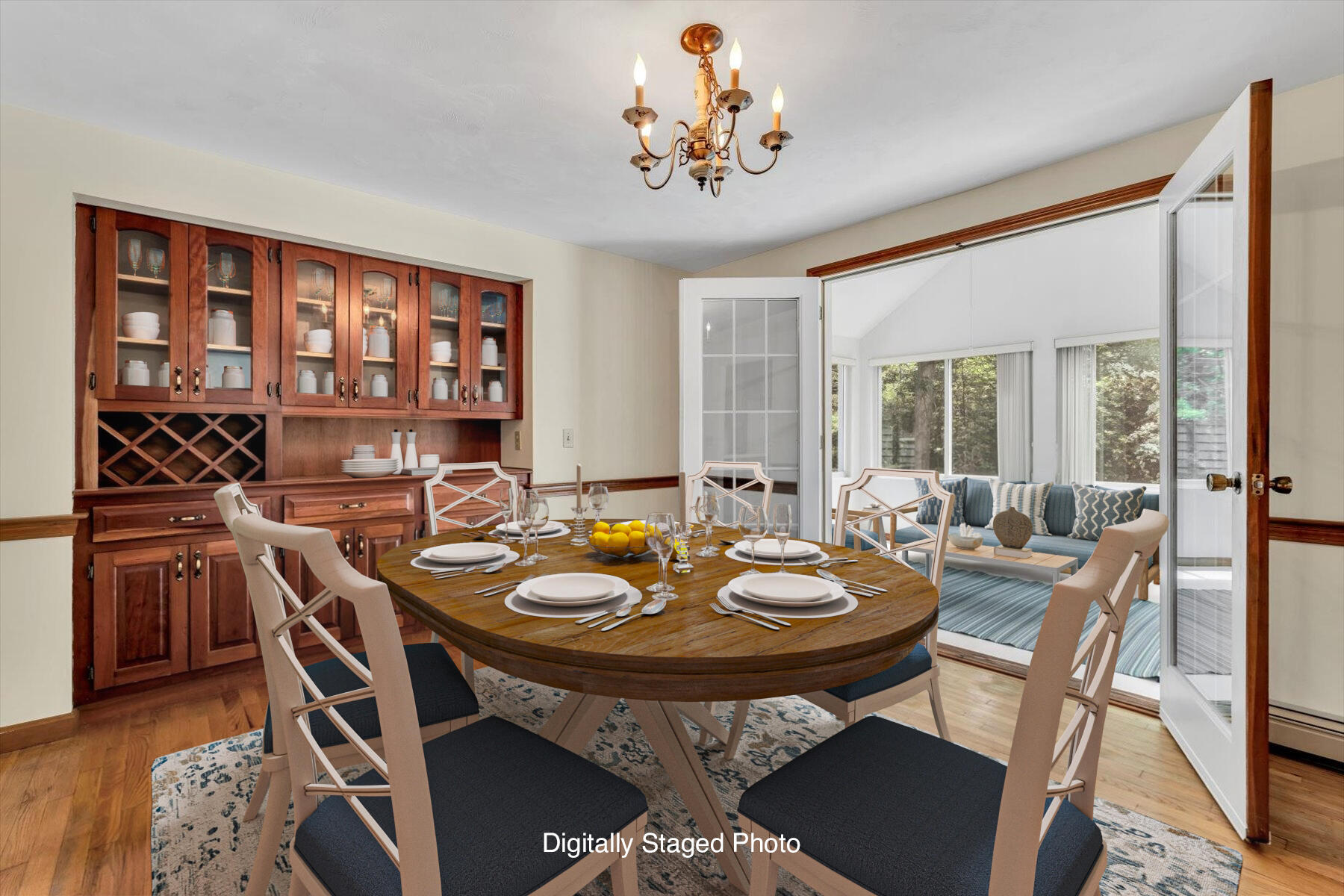 18 Pheasant Run Road Harwich, MA 02645 - Photo 11 of 51 a view of a dining room and livingroom with furniture wooden floor a rug a fireplace and windows