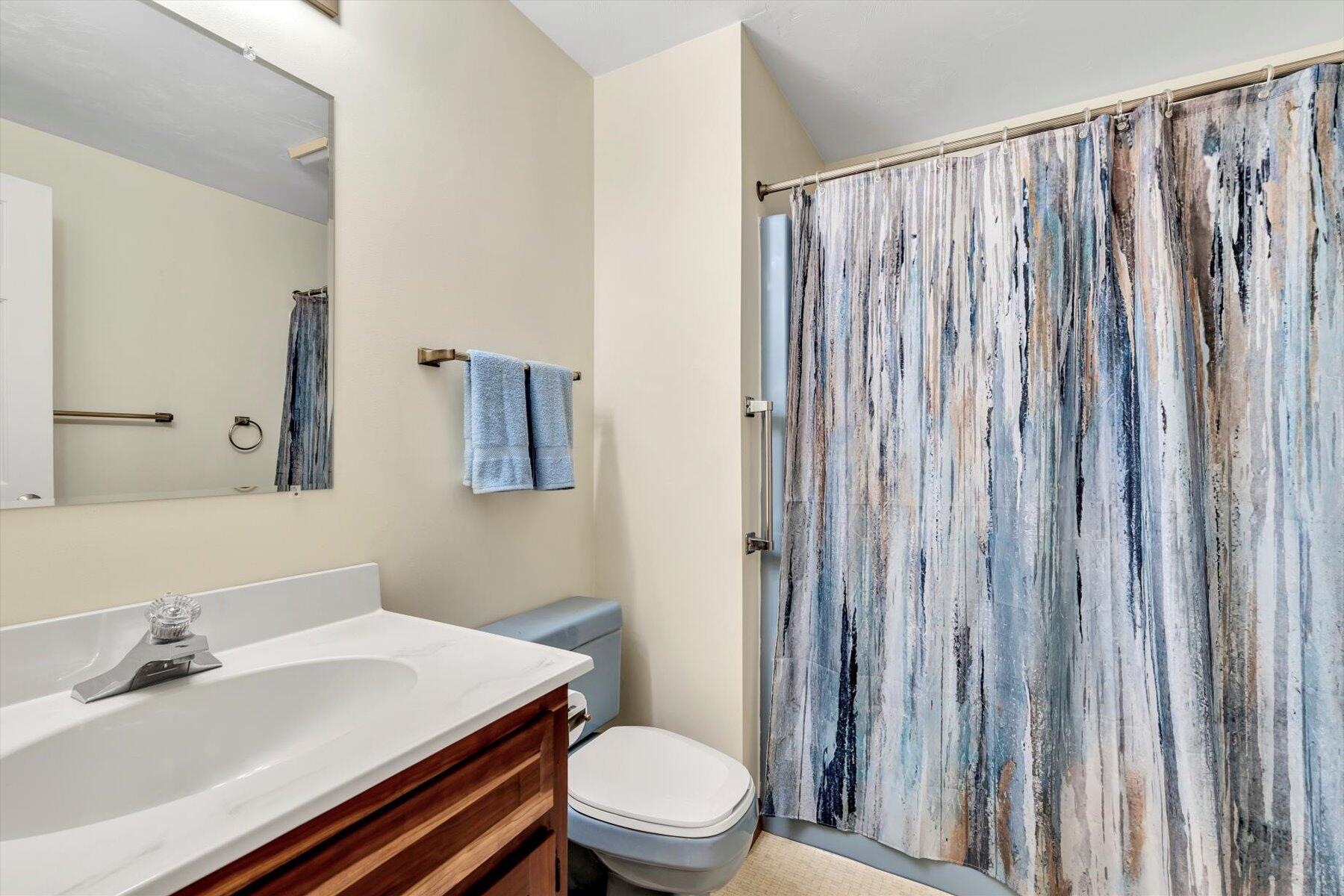 18 Pheasant Run Road Harwich, MA 02645 - Photo 24 of 51 a bathroom with a sink a toilet a mirror and shower curtain